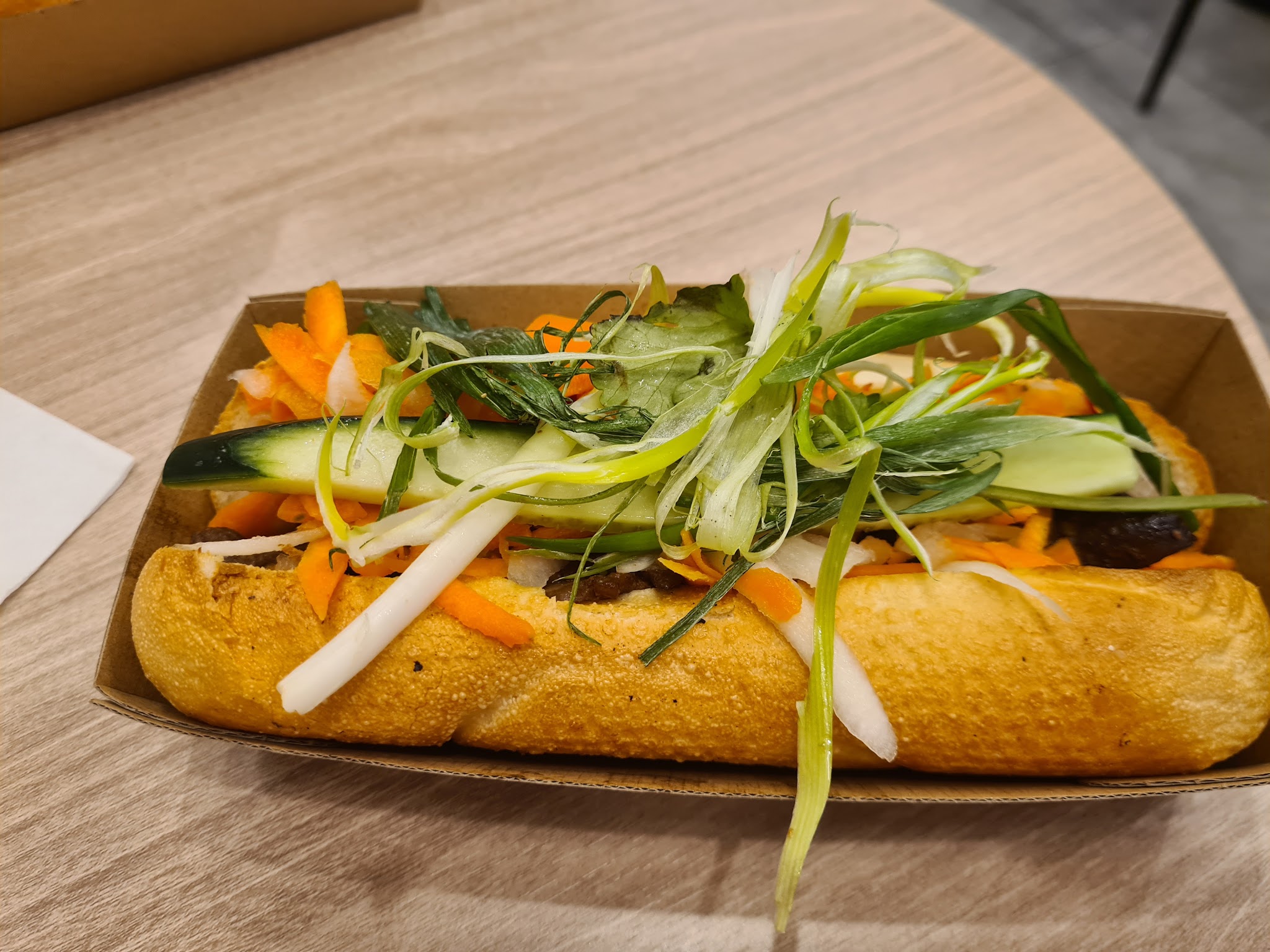 A bánh mì loaded with pickled carrot, daikon, cucumber and spring onion